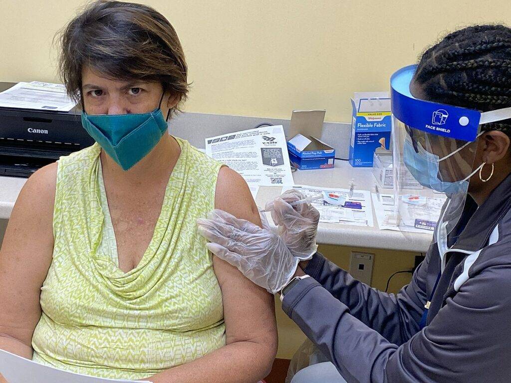 Person receiving COVID-19 vaccination